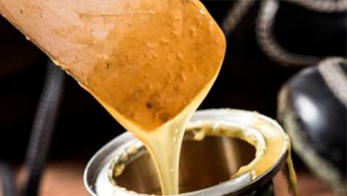 A construction worker is guiding a cement mixer truck chute as concrete is being offloaded for a new house footing. The background is overcast blue sky with another worker, wearing a safety vest, cleaning a mixer chute. http://www.banksphotos.com/LightboxBanners/Concrete.jpg