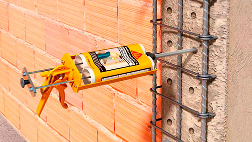 A construction worker is guiding a cement mixer truck chute as concrete is being offloaded for a new house footing. The background is overcast blue sky with another worker, wearing a safety vest, cleaning a mixer chute. http://www.banksphotos.com/LightboxBanners/Concrete.jpg